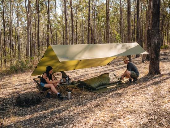 Couple setting up 3mx4m camping tarp setup.