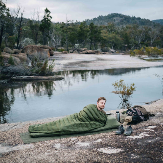Camper using Alton 10 Degree Summer Sleeping Bag on hike